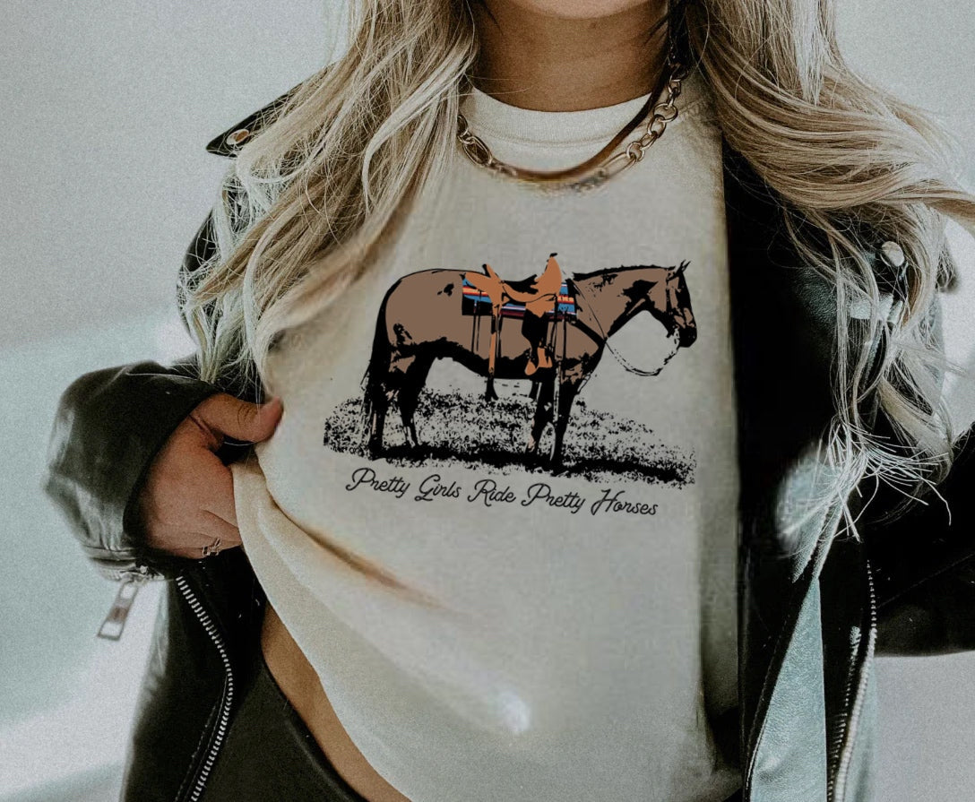 Pretty Girls Ride Pretty Horses Graphic on Gildan Softstyle Natural Shirt – Graphic Tee, Long Sleeve & Crewneck.