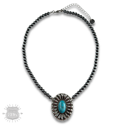 Western sunburst pendant on burnished silver bead necklace
